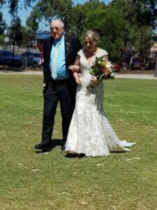 Sick dad walks daughter down the aisle after she received a generous wedding dress gift